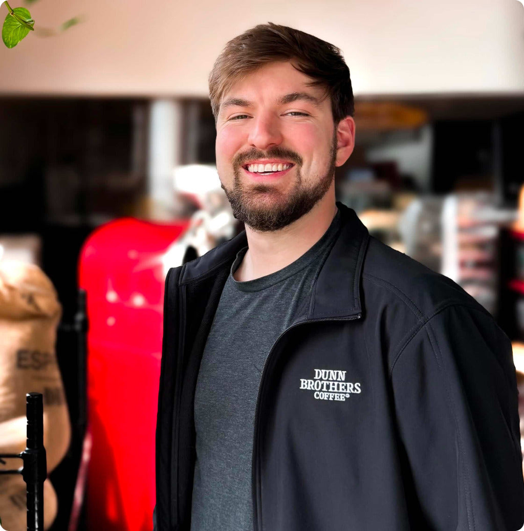 Dunn Brothers Coffee barista smiling inside the coffee shop